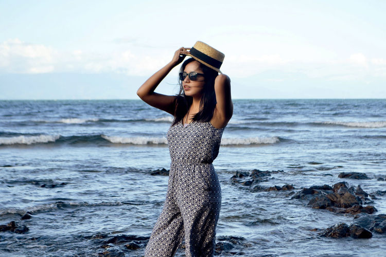 Beautiful woman standing at sea shore