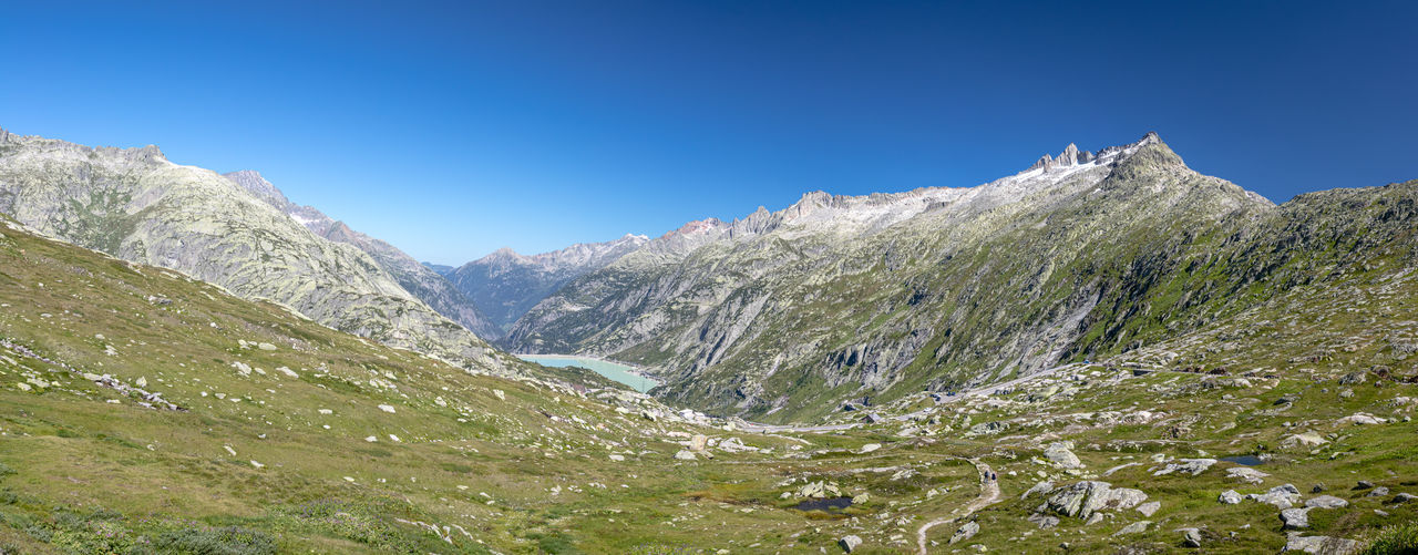 Sunny morning panorama on the top of grimselpass. colorful summer in swiss alps, canton of bern. 