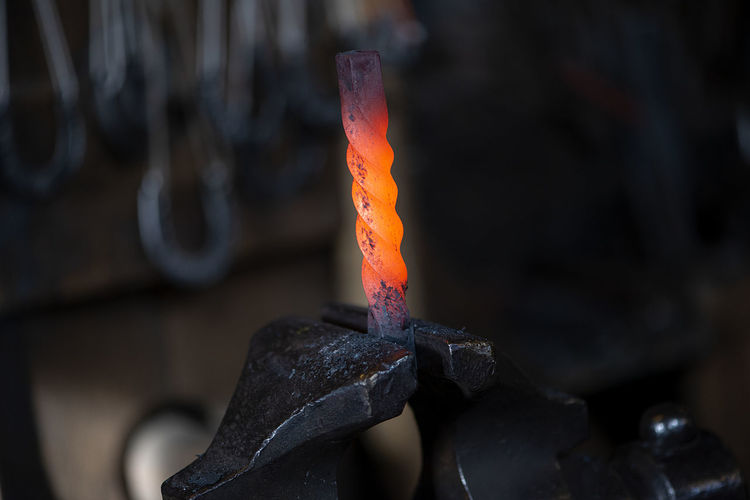 Close up of hot iron in blacksmith's workshop