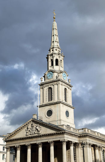Low angle view of clock tower against cloudy sky at national gallery