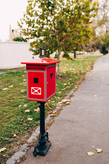 Red metal mailbox on the street. blurred background. high quality photo