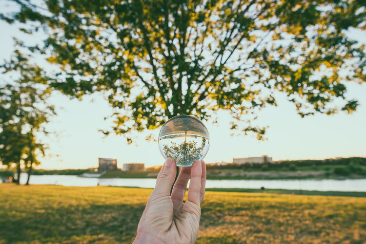 Close-up of hand holding crystal ball