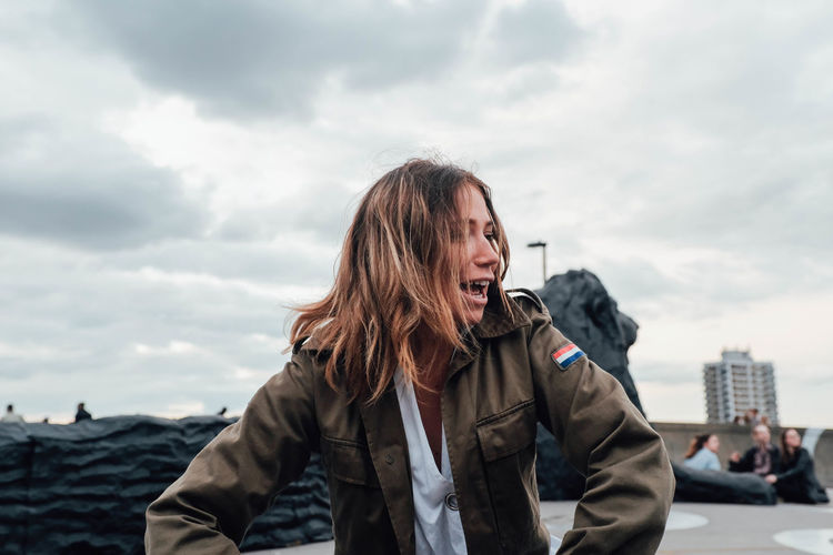 Casual Clothing City Cloud - Sky Day Focus On Foreground Front View Leisure Activity Lifestyles Nature One Person Outdoors People Portrait Real People Sky Smiling Standing Warm Clothing Young Adult Young Women