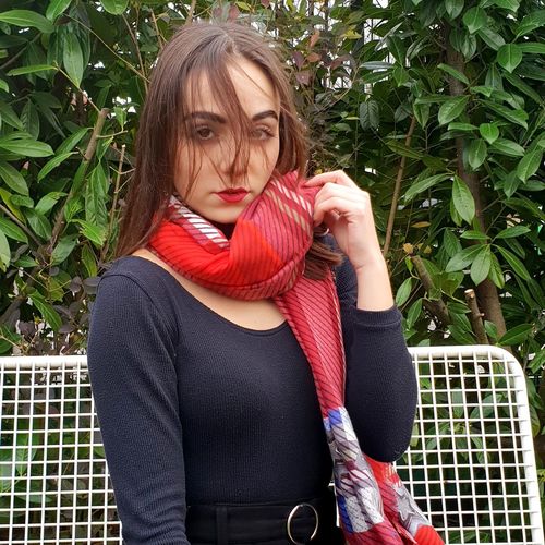 Portrait of woman standing against plants