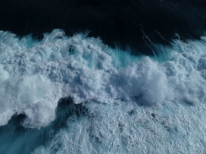 High angle view of waves splashing in sea
