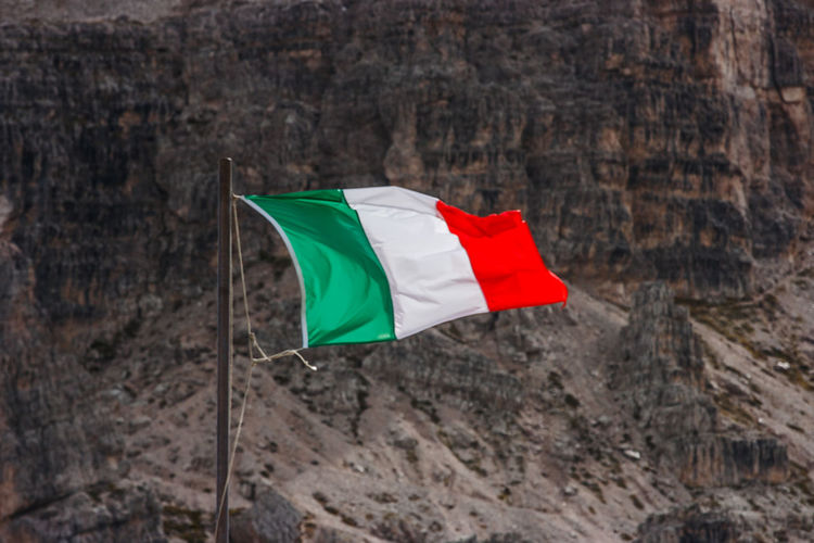 Italian flag waving against mountain