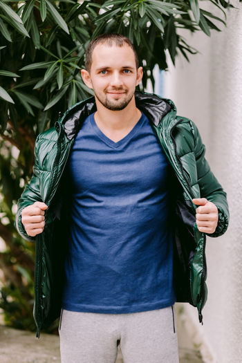 Portrait of man wearing jacket standing outdoors