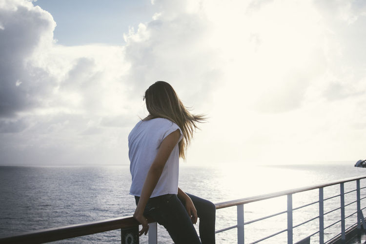Rear view of woman looking at sea from observation point