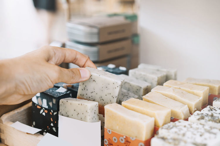 Woman picking scented soap bar at zero waste shop