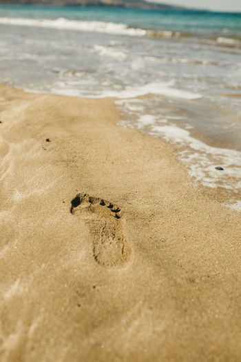 High angle view of footprints on sand at beach