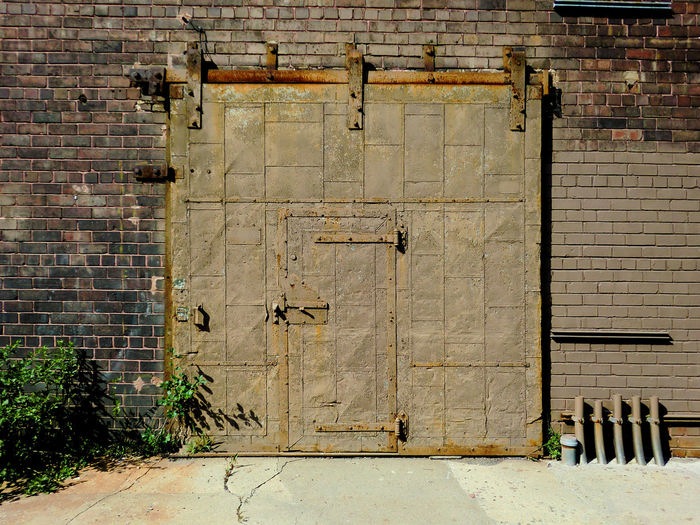 Brick wall with closed doors
