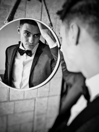 Portrait of man with reflection on mirror