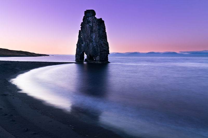 Rock formation on beach against sky during sunset in hvítserkur , iceland