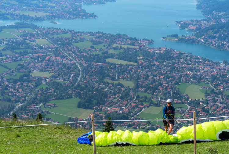 Man with parachute standing on mountain