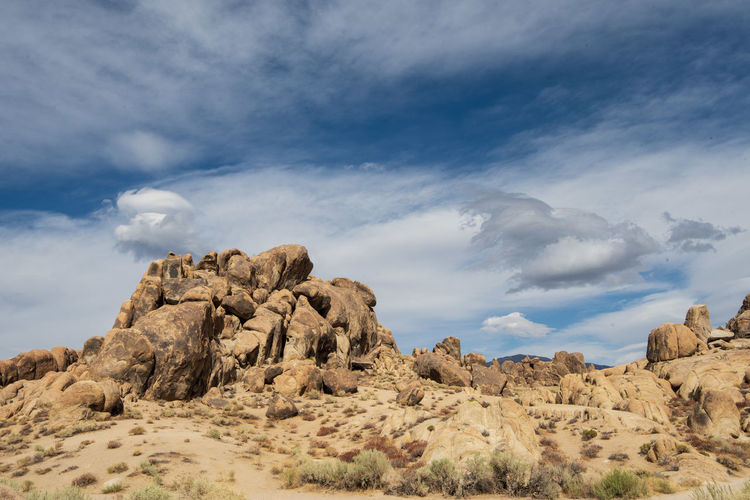 Low angle view of desert rock formations against sky with cloud formations
