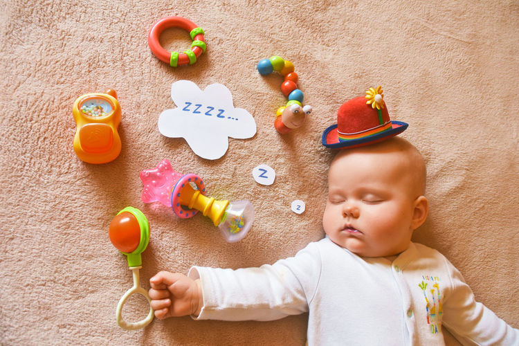 High angle view of baby playing with toy