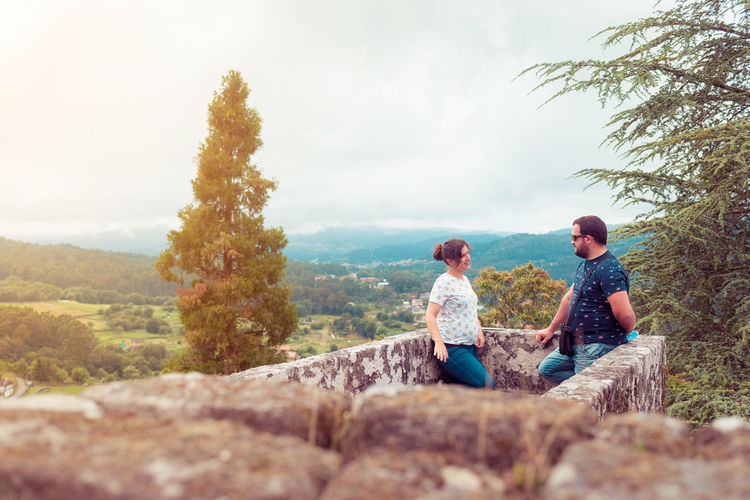 Couple talking while standing on observation point