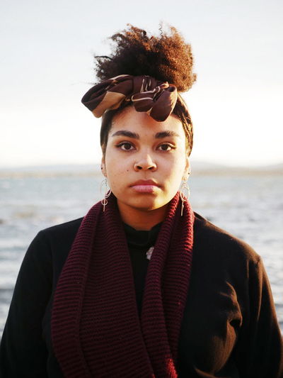 EyeEmNewHere VSCO Vscocam Fashion Style Cold Tones Moody Nigerian Australian Landscape Beach Nature Photography Windy Dusk Sunlight Shadow Headscarf Natural Beauty Strong Woman Powerful Portrait Beautiful Woman Young Women Beach Looking At Camera Beauty Front View Sea Beautiful People Headshot