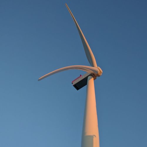 Low angle view of windmill against clear blue sky. windmill with two blades
