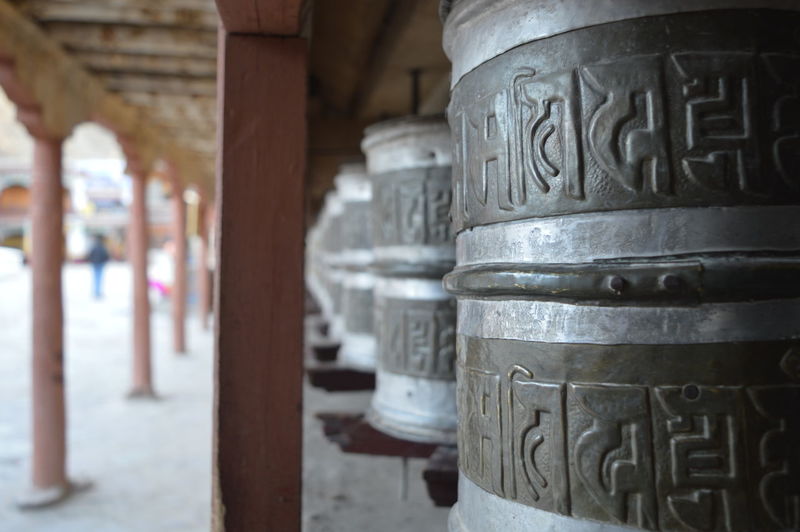 Close-up of prayer wheels in temple