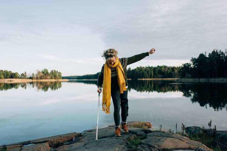 Injured woman walking along the coast in beautiful sweden