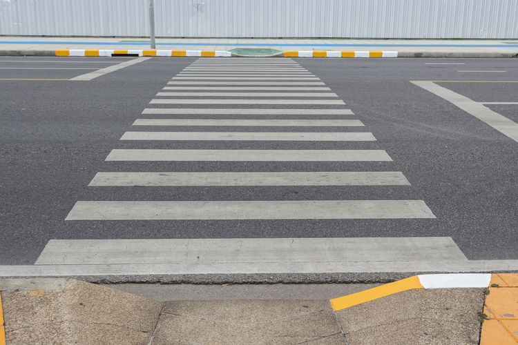Line of crosswalk way across road in bangkok, thailand