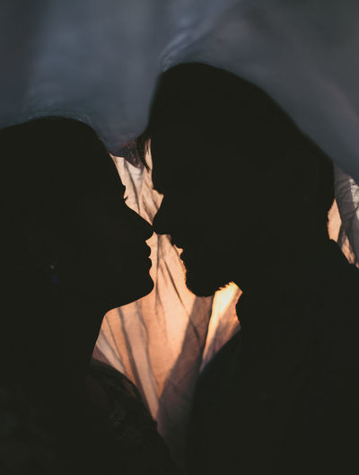 Close-up of couple kissing in the dark