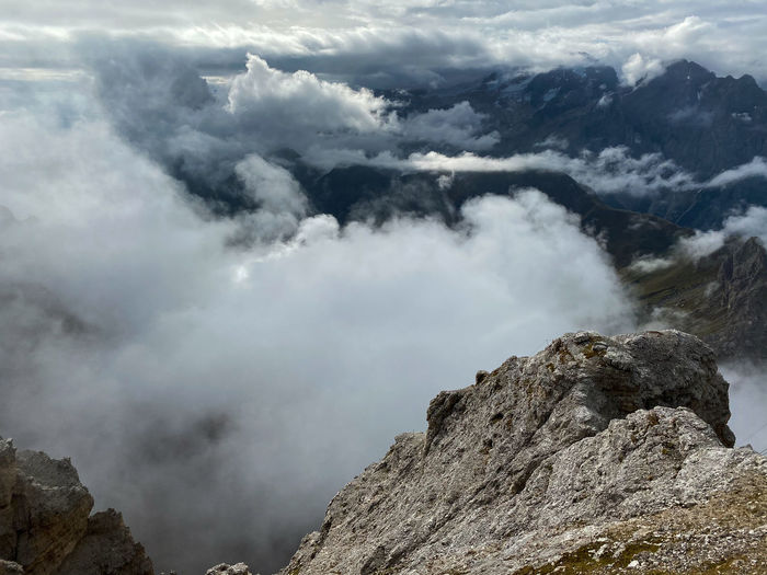 View of upcoming clouds over dolomites mountains, seen from sass pordoi, south tyrol, italy