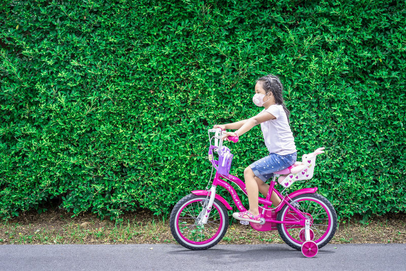 Side view of girl riding bicycle