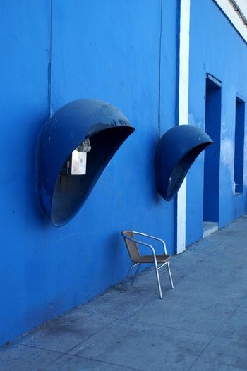 Pubblic phones against blue wall