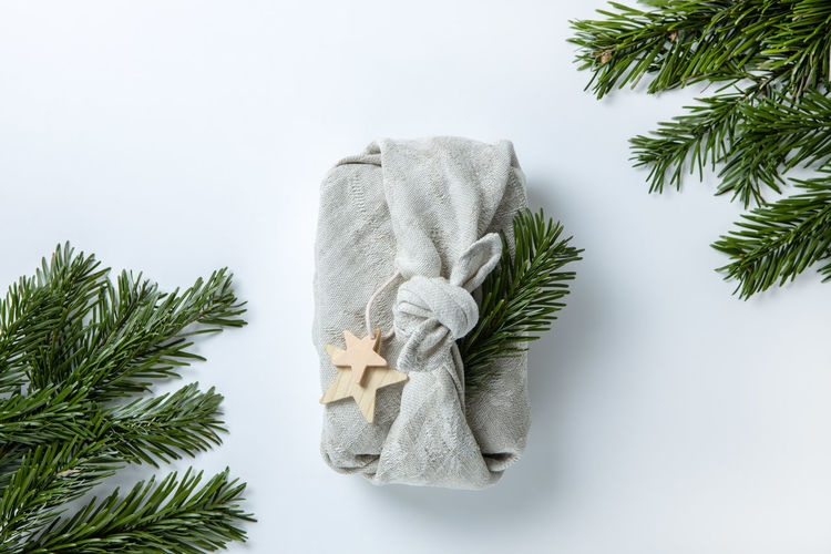 Zero waste  christmas gift wrapping in traditional japanese furoshiki style in linen fabric