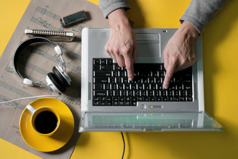 Cropped hands using laptop