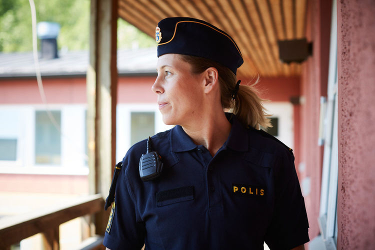 Policewoman looking away while standing in balcony at police station