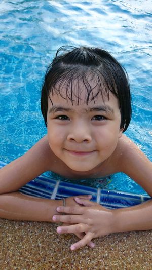 Portrait of cute girl in swimming in pool