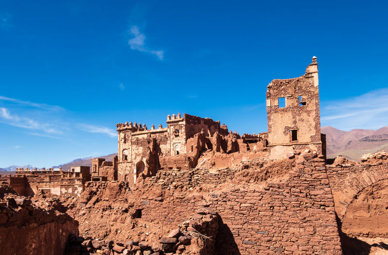 Low angle view of historic building against blue sky