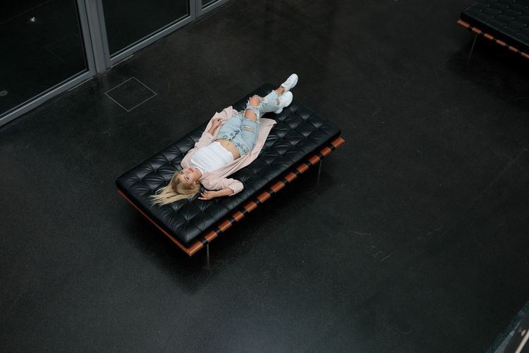 High angle portrait of woman lying on mattress