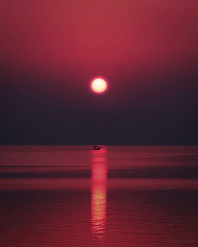 A boat in the sea at sunrise