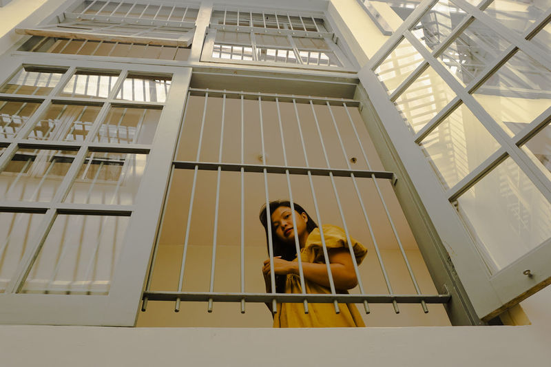 Low angle view of woman on window