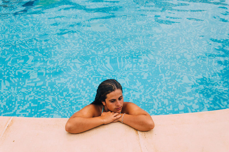 Portrait of a young woman sitting in water