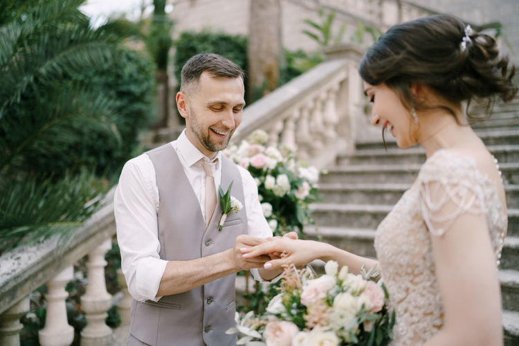 Portrait of bride and bridegroom holding bouquet