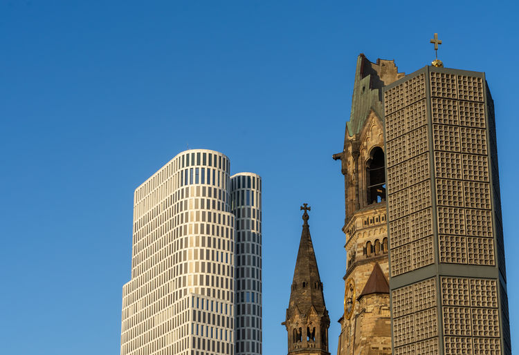 Church against modern building and sky