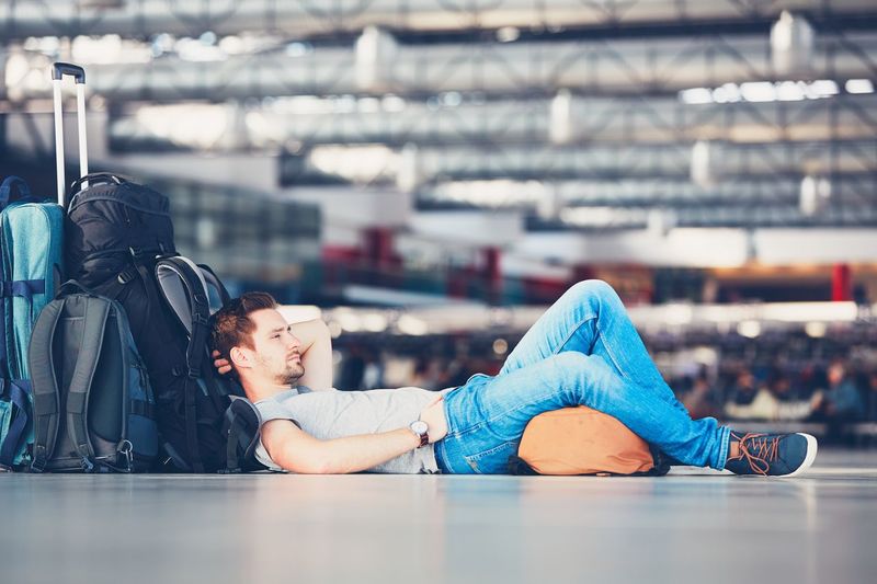Side view of man luggage waiting at airport