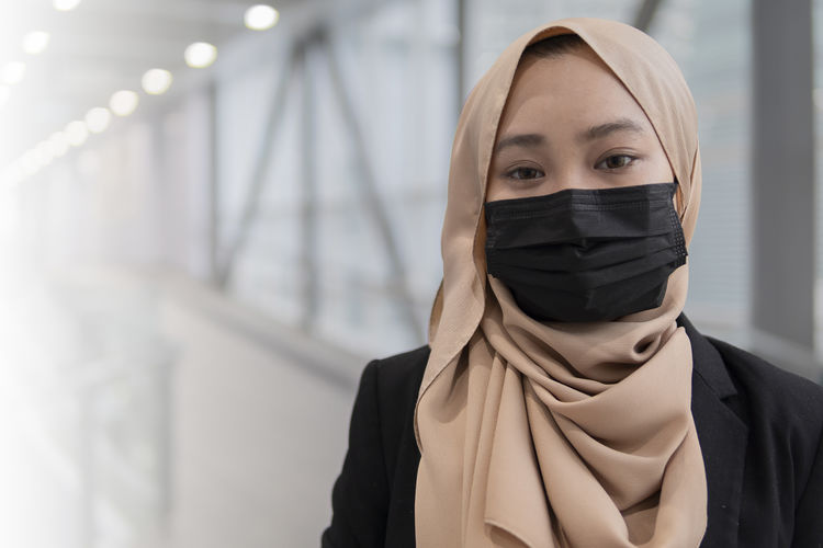Malay woman wearing face mask executive outdoor close-up portrait
