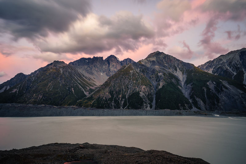 Scenic view of mountains and lake against cloudy sky