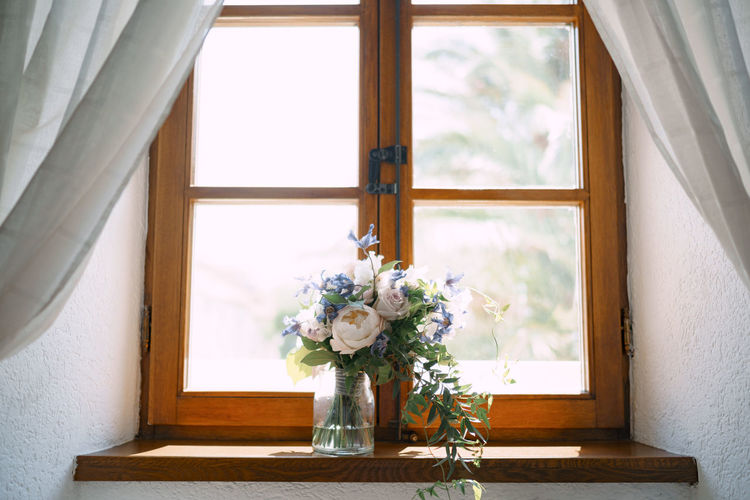 FLOWER VASE ON WINDOW SILL OF HOME