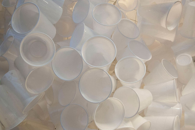 Many white disposable plastic cups, waste prevention and waste separation
