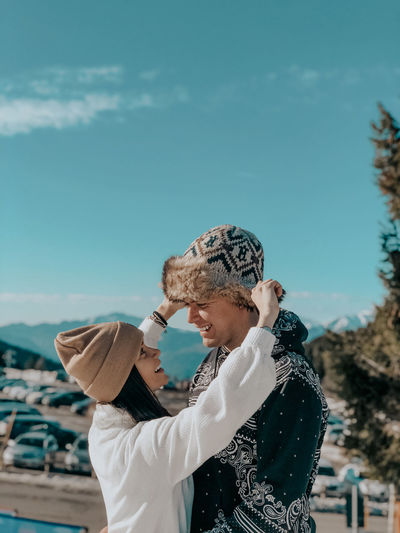 Side view of couple embracing during winter outdoors