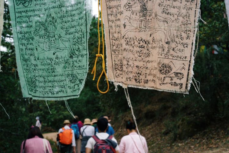 Prayer flags with people in background