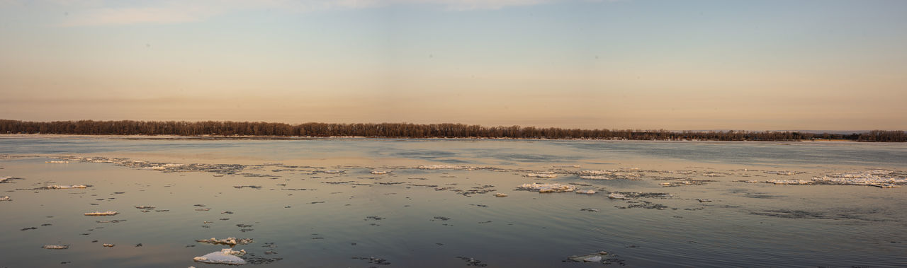 Scenic view of lake against sky during winter
