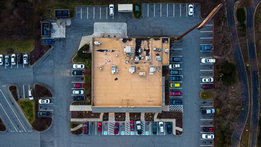 Aerial view of cars on road in parking lot